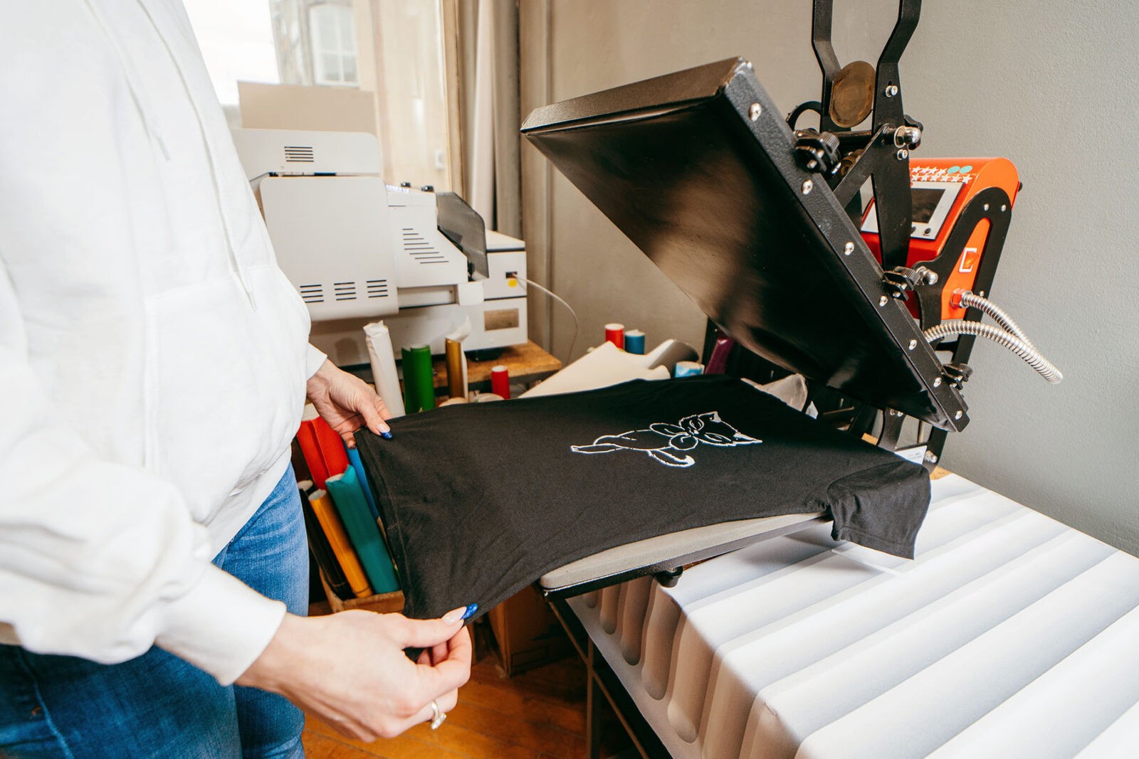 Desktop heat press for printing images on fabric.